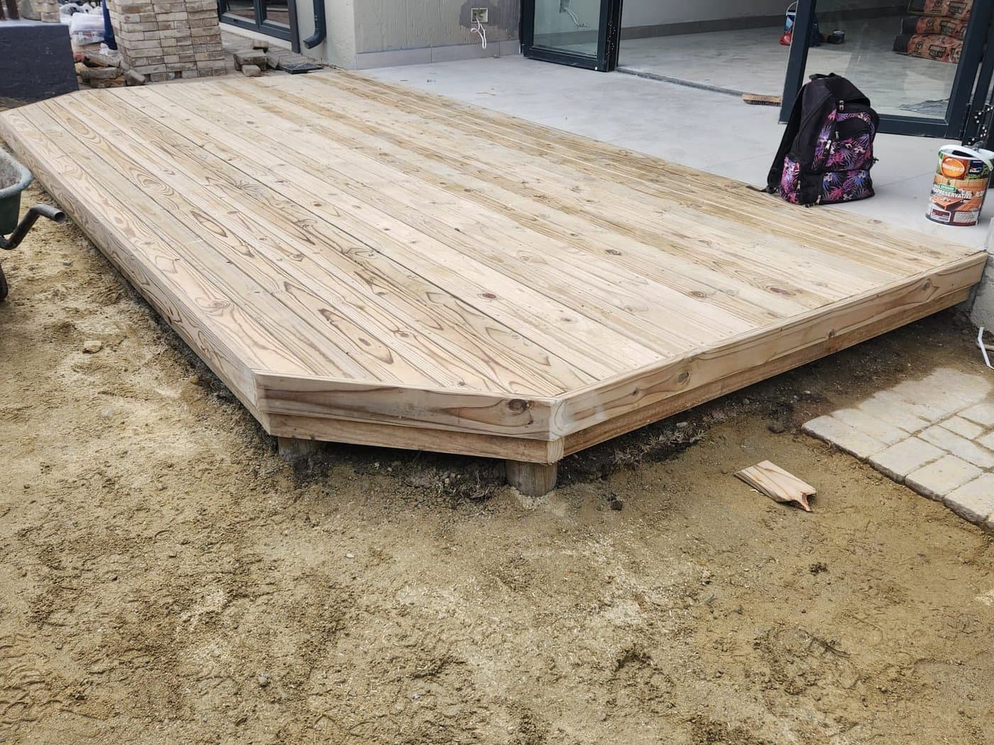 A finished timber deck laid on a paved terrace