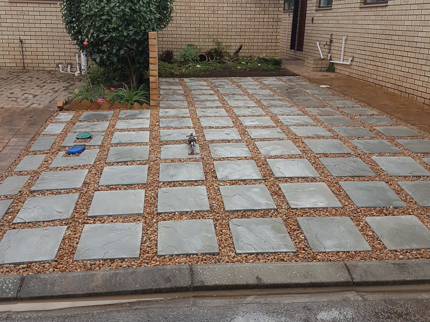 A paved courtyard with planted joints between the slabs