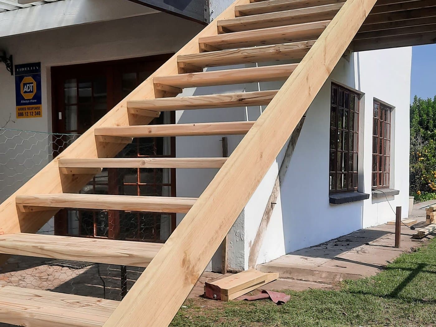 A timber staircase built against the side of a house
