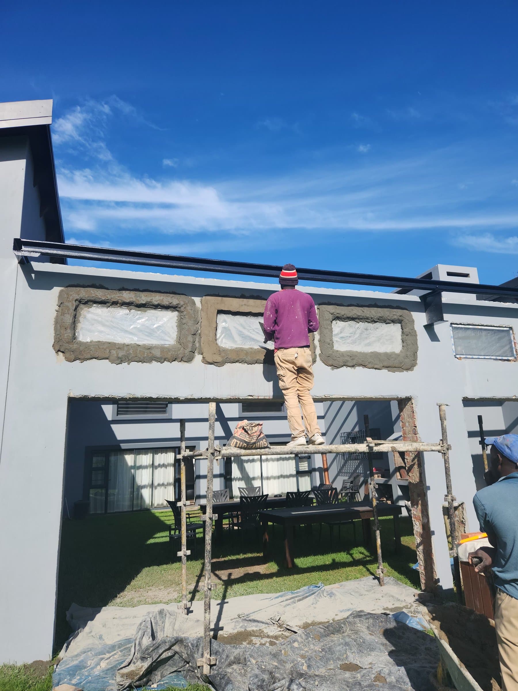 Painting the facade of a home from a mobile scaffold