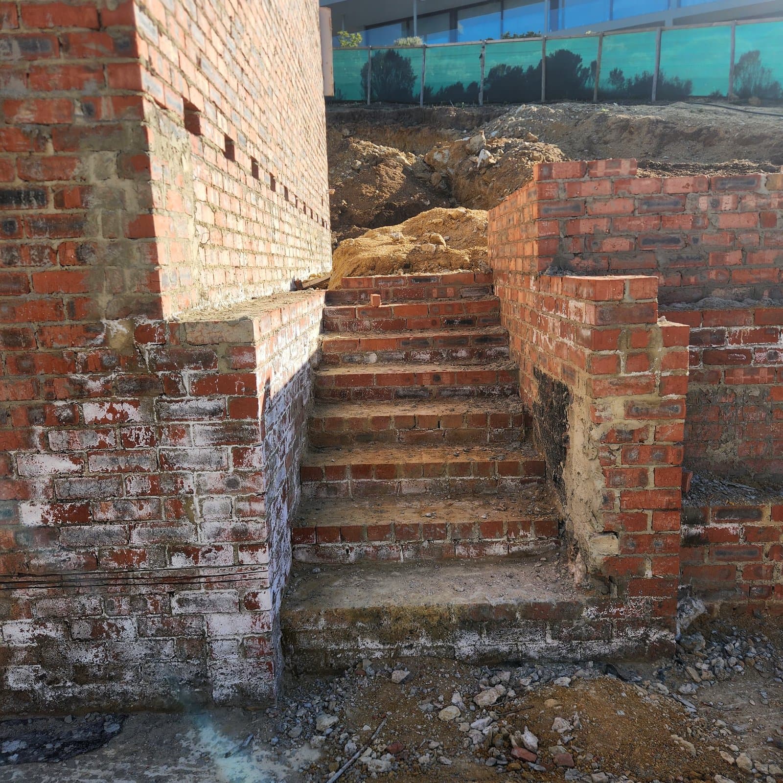 Face brick steps and retaining brickwork built into a bank
